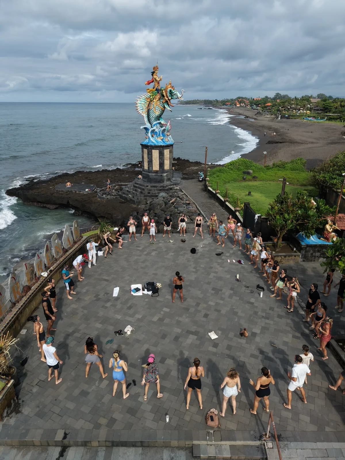 A full circle of ravers by the mermaid statue