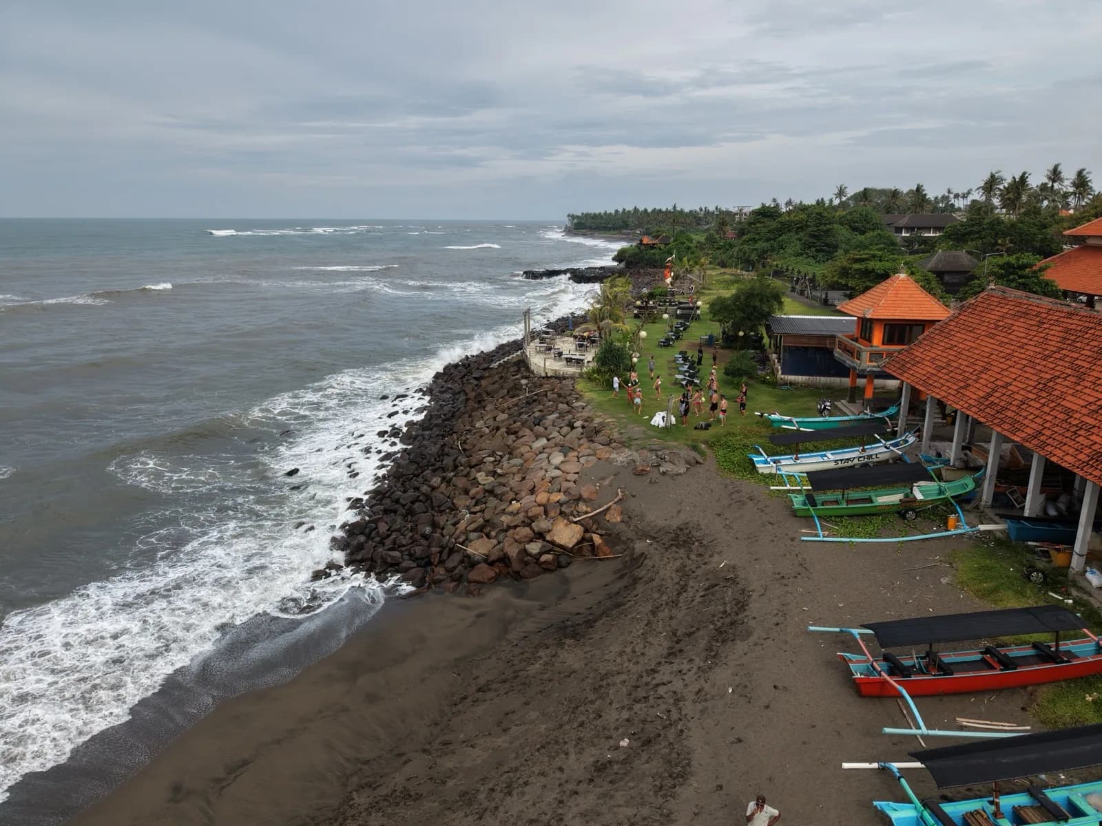 Fishing boats and warungs along the shore