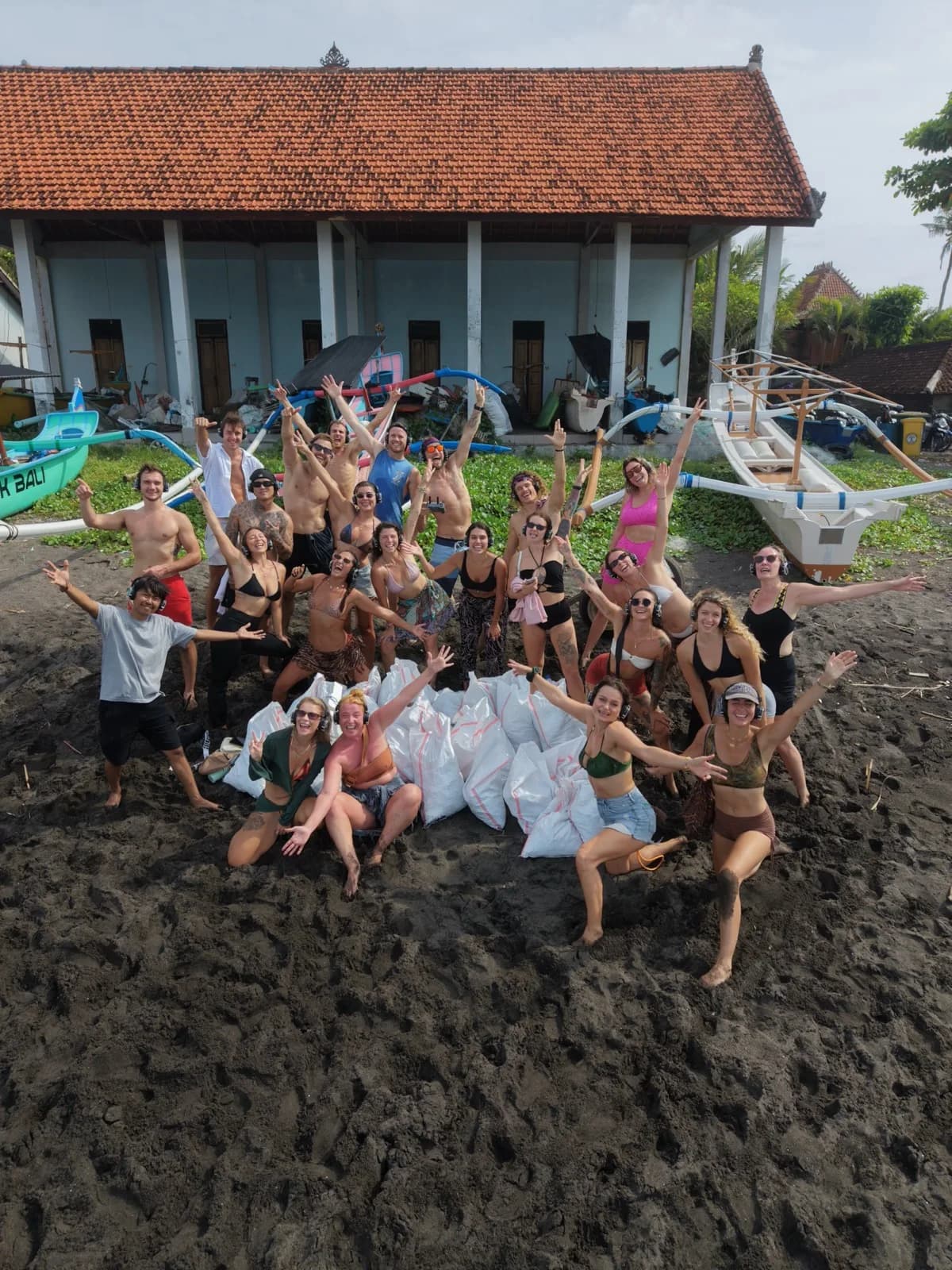The whole crew by the warung and the boats